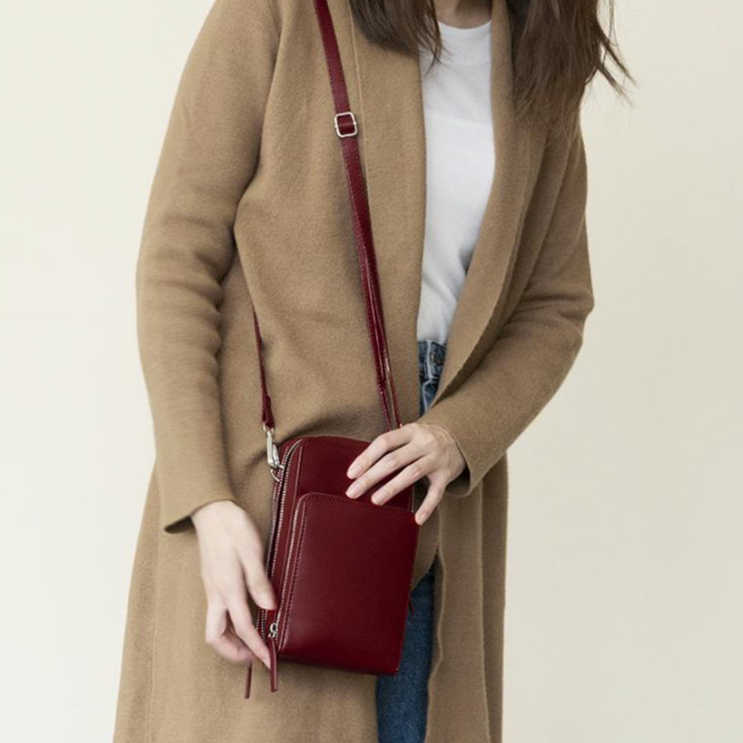 Chic Leather Phone Clutch with Safety Features and Adjustable Strap
